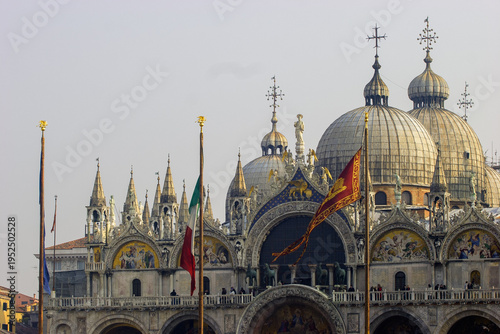 St. Mark's Basilica in Venice, Italy, with flags flying in front.