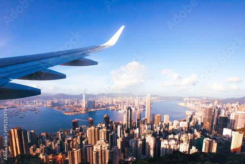 Airplane Wing Flying Over Hong Kong Skyline and Victoria Harbour