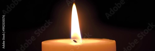 Burning candle flame on dark background with copy space, calm meditation memorial video banner background, spirituality remembrance and peaceful reflection concept.