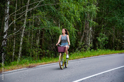 Wallpaper Mural Young woman riding bike bicycle on road. Outdoor activity. Bicycle activity. Sport and active leisure lifestyle. Young girl ride bike. City bike transport. Sport bicycle with woman or girl Torontodigital.ca