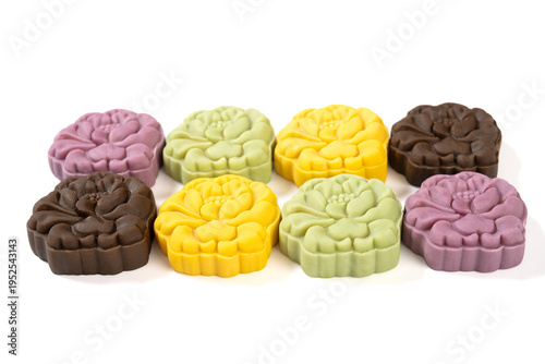angle view colorful flower shape snowy mooncakes on white