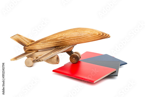 airplane model on top of several passports on white background