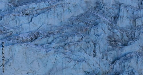 Aerial drone shot showing a vast snow-covered glacier landscape near Lobuche surrounded by rugged Himalayan terrain in the Everest region of Nepal.
