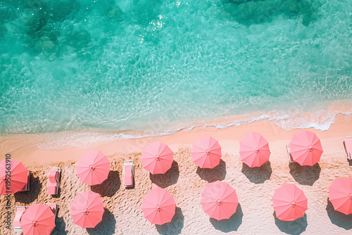 Top view of a beach with pink striped lounge chairs by the sea, under a clear blue sky, in a relaxing summer atmosphere filled with sunshine and tranquility