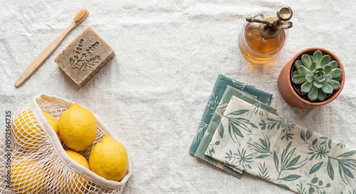 Sustainable lifestyle flat lay with eco-friendly everyday essentials in transformative teal and earth tone palette on natural linen