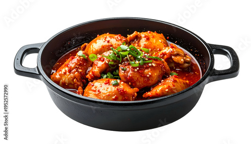 Chicken dish in a dark, handled pot with red sauce and green herbs