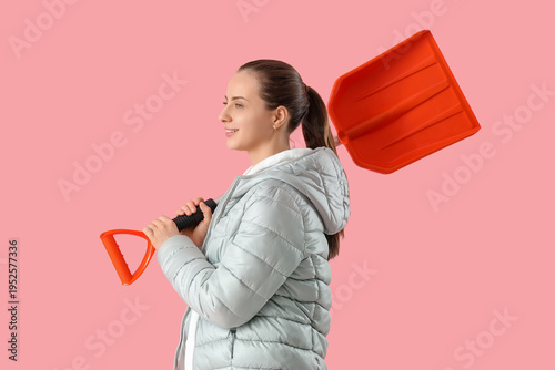 Young woman with snow shove...