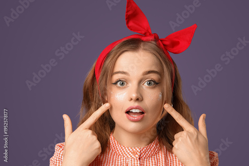 Surprised young woman point...