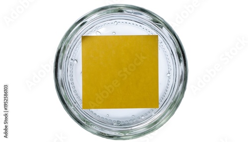 Top-down view of glass jar with yellow square on bottom; clean clear simple