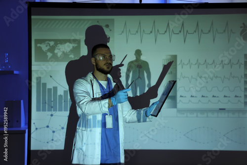 Male doctor with clipboard ...