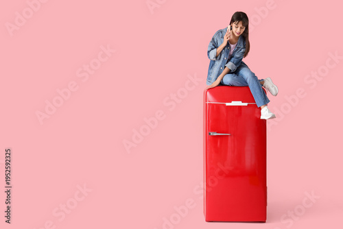Young happy woman sitting o...