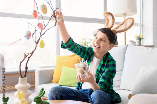 Teenage boy in bunny ears d...