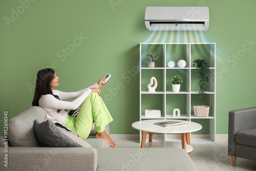 Young woman with remote con...