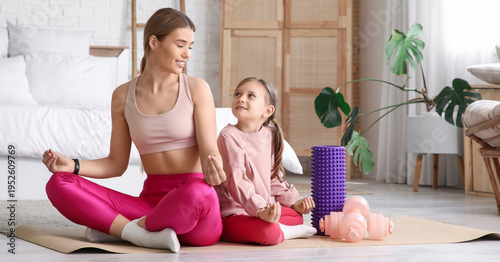 Sporty young mother and her...