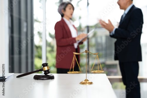 Attorney performs legal tasks to prepare cases. Lawyers at desk consulting, discussing to advise and represent client in criminal or civil proceeding, legal matter.