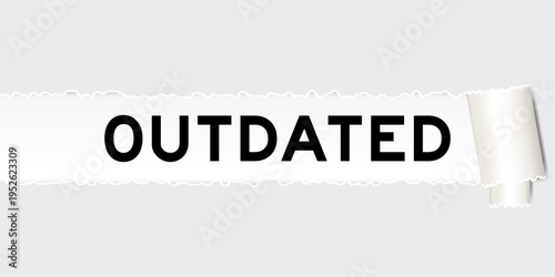 Ripped gray paper background that have word outdated under torn part