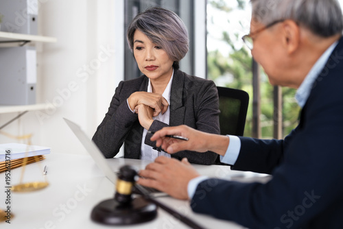 Lawyer team diligently reviewing legal documents at desk.Law and Legal services concept.