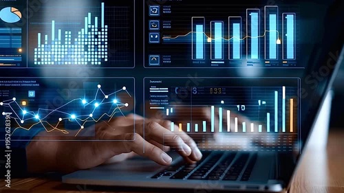 Financial analyst typing on laptop with holographic data dashboard