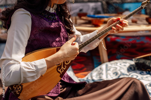 Skillful Woman Enjoying Traditional Tune With Detailed Surroundings Highlighting Cultural Ambiance