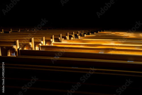 Bild auf Leinwand Sunlight streaming into empty church pews creating dramatic light