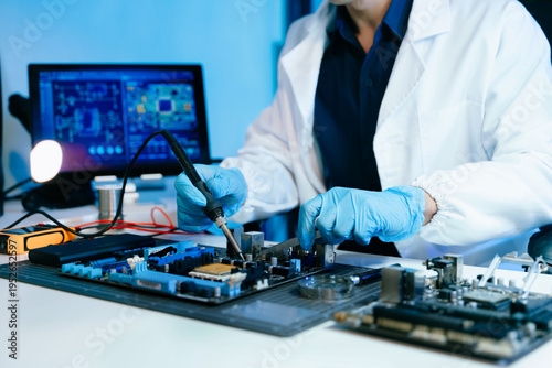 Technician repairing computer motherboard with soldering tools in a high-tech laboratory, focusing on electronics engineering, hardware diagnostics, cybersecurity systems