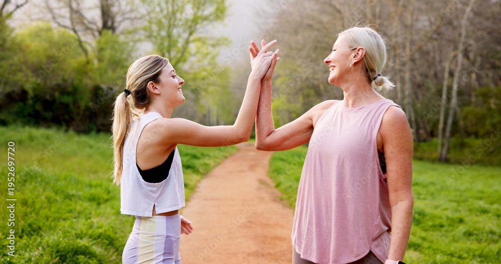 Obraz premium Fitness, women and high five in nature for support, well done and energy for exercise. Mature mother, girl and hand gesture on mountain trail for motivation, healthy relationship or bonding with care