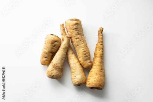 Fresh parsnip roots winter vegetables top view light surface