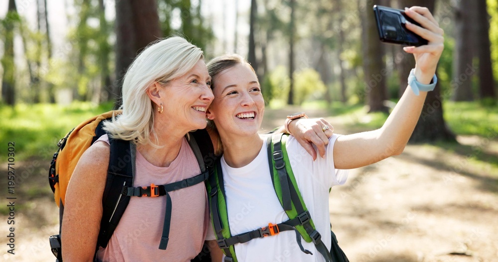 Obraz premium Nature, hiking and women with smile for selfie, document memory and bonding for profile picture. Outdoor, senior mother and daughter with photography for social media, fitness experience and wellness