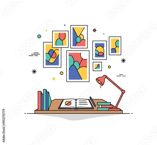 Artist studio corner with a simple desk and sketchbook positioned under a gallery style arrangement of colorful wall art. The composition highlights