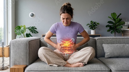 Woman sitting on sofa suffering from severe stomach ache. Illustration of inflamed human intestine area. Physical pain and medical disorder concept. Healthcare and digestive system disease.
