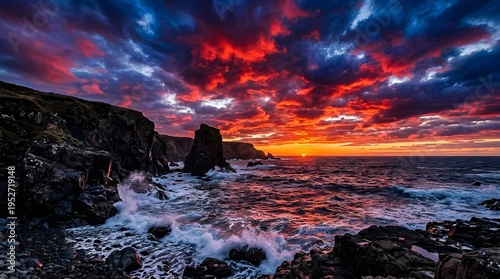 Dramatic Coastal Sunset Over Rugged Cliffs With Vibrant Red And Blue Sky And Crashing Ocean Waves