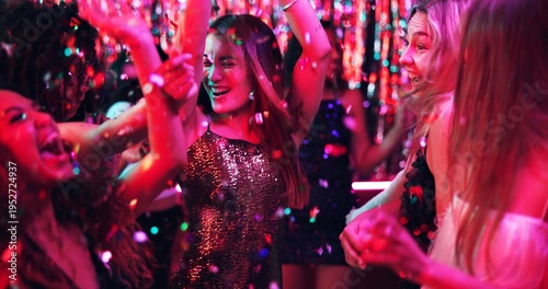 Tableau sur toile Women, dance and glitter in night club for party, celebration and excited for New Year