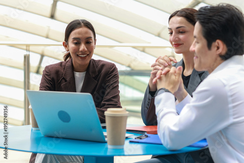 Group of young smart business people working, communicating outside modern office together with colleagues. Business teamwork has stategic planning together with senior business woman.