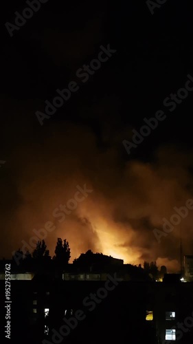 Night fire smoke and explosion sounds behind tree and house silhouettes