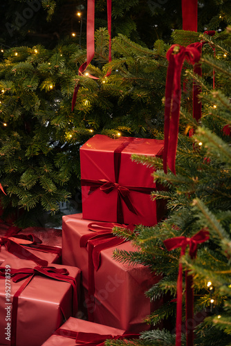Beautiful Christmas tree indoors with red coloured presents under