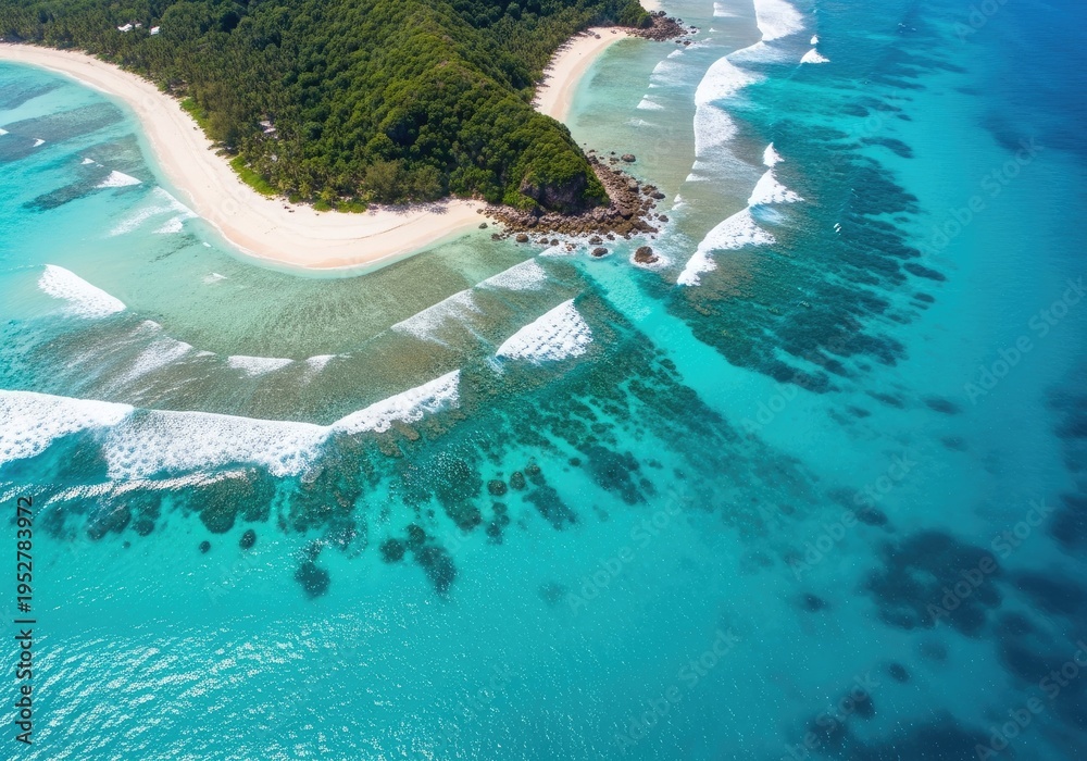 Fototapeta premium Aerial view captures turquoise ocean waves washing onto a secluded tropical beach cove.