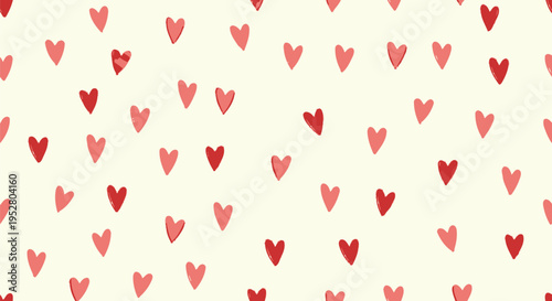 cute simple seamless pattern of small hearts in two shades of pink and red on a light yellow cream background for valentines day or love concept romantic celebrations