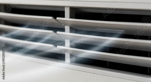 Close-up view of air purifier vent with subtle airflow blur emanating from appliance louvers. Freshness and clean air circulate through air purifier vent, indicating healthy environment.