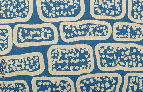 Photos Blue fabric texture with abstract beige pattern and random speckles creating a c