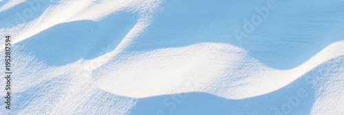 Snow texture. Wind sculpted patterns on snow surface. Wind in the tundra and in the mountains on the surface of the snow sculpts patterns and ridges. Arctic, Polar region. Winter panoramic background.