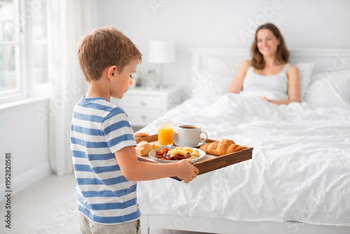 Son bringing breakfast in bed to mother for Mother's Day