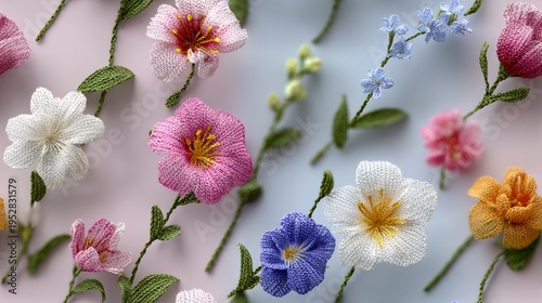 Delicate hand-embroidered flowers in pastel hues. Pink, white, blue, and yellow blooms with green stems. Soft focus background highlights texture and color. Ideal for spring, wedding