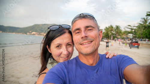Wallpaper Mural Tourists take a selfie with the senic view of Patong Beach at sunset with palm trees and vibrant reflections Torontodigital.ca