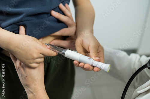 A young patient holds an insulin or weight-loss pen device while a healthcare professional guides the administration process.