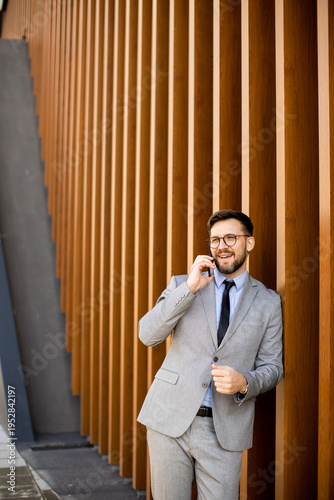 Man in suit talks on phone ...