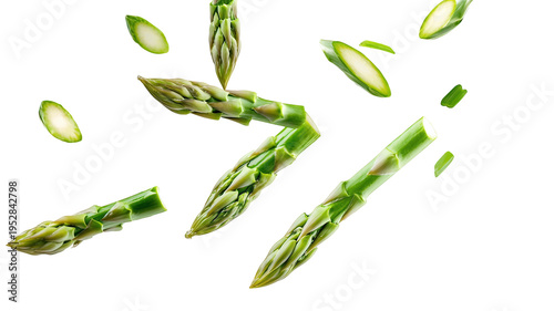 Fresh green asparagus spears and slices floating in mid-air against a black background on Transparent Background