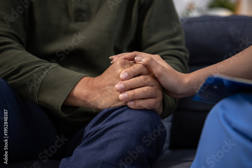 Foto Close up of medical professional nurse gently holding hand of sad patient showin
