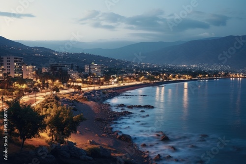 A captivating view of a beach and city at night. Perfect for travel brochures or cityscape articles.