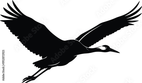 A minimalist black silhouette of a graceful crane bird captured in mid-flight against a white isolated on white background