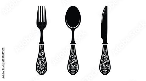 A set of elegant black utensils with ornate handles on a white background